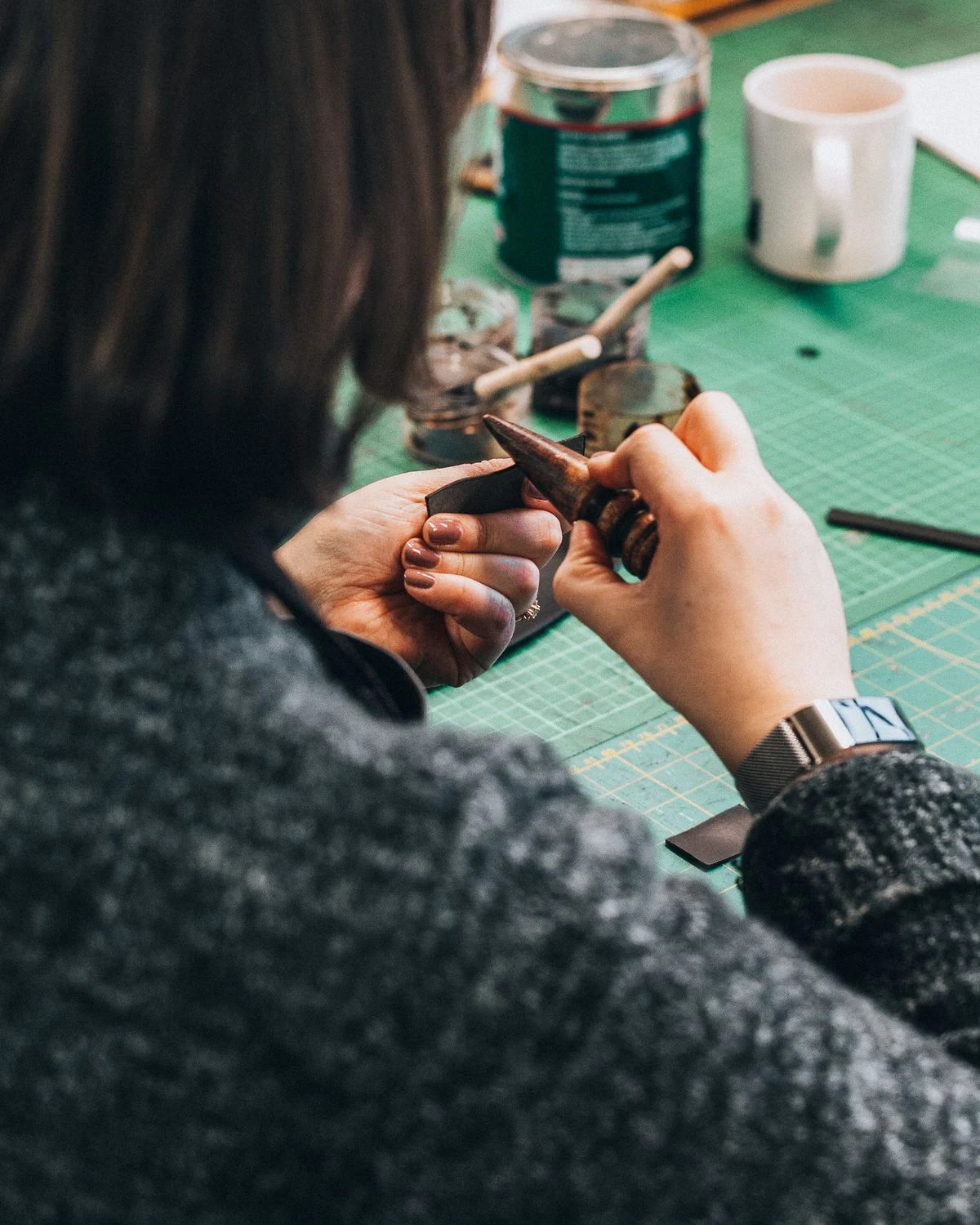 Burnishing the edge of a leather wallet — handmade craftsmanship at Prime Scope