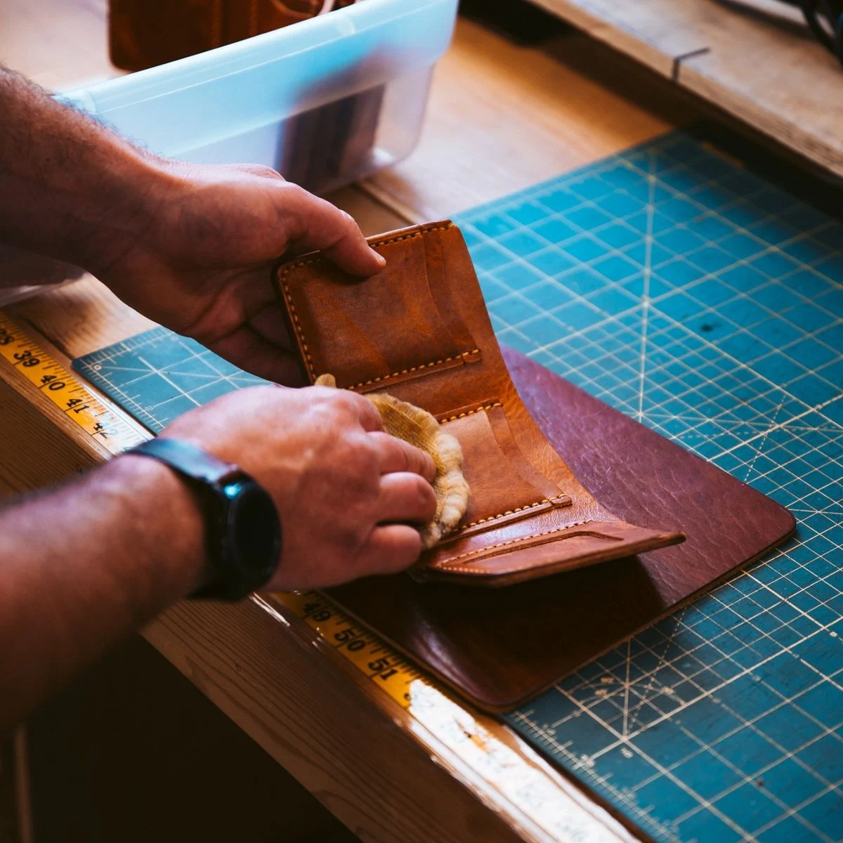 Hands crafting a leather wallet — B2B leather manufacturing by Prime Scope